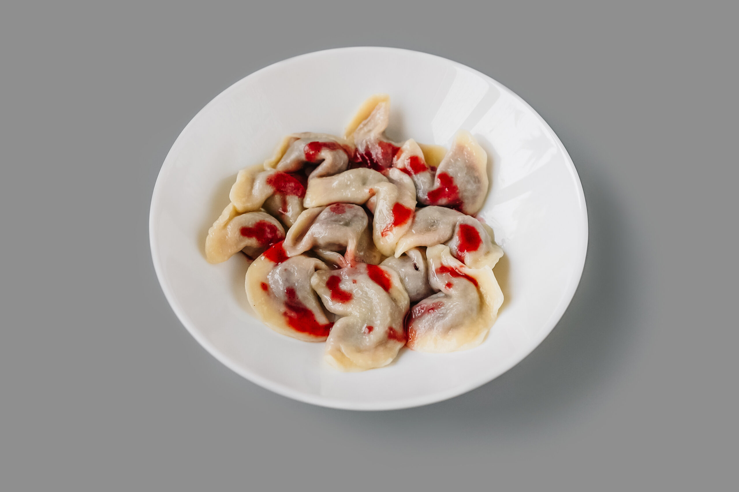 plate with strawberry pierogi