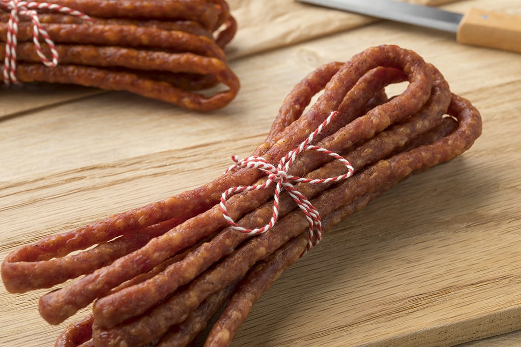 Polish thin Kabanosy sausage close up on a cutting board