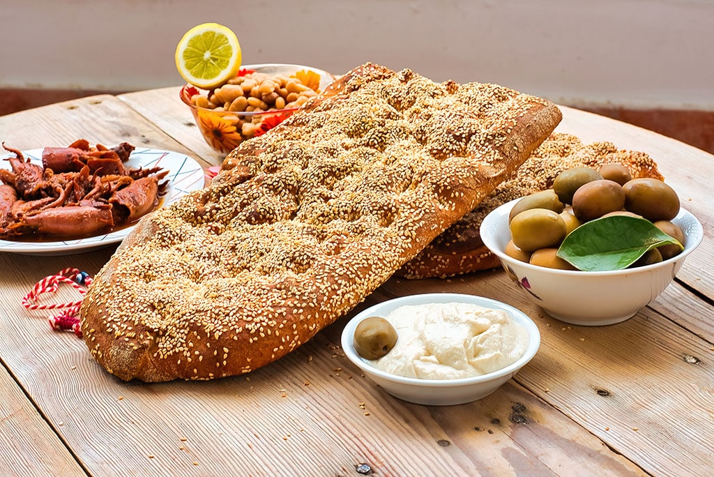 Traditional greek bread ( lagana ) , Clean Monday food , lagana bread , olivesn seafood , greek taramas .